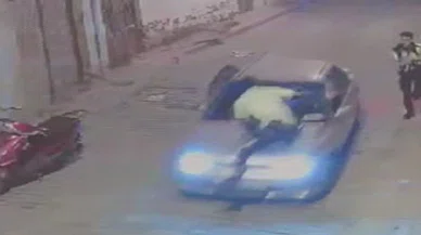 Kaçan şahıs polisi metrelerce kaputunda götürdü
