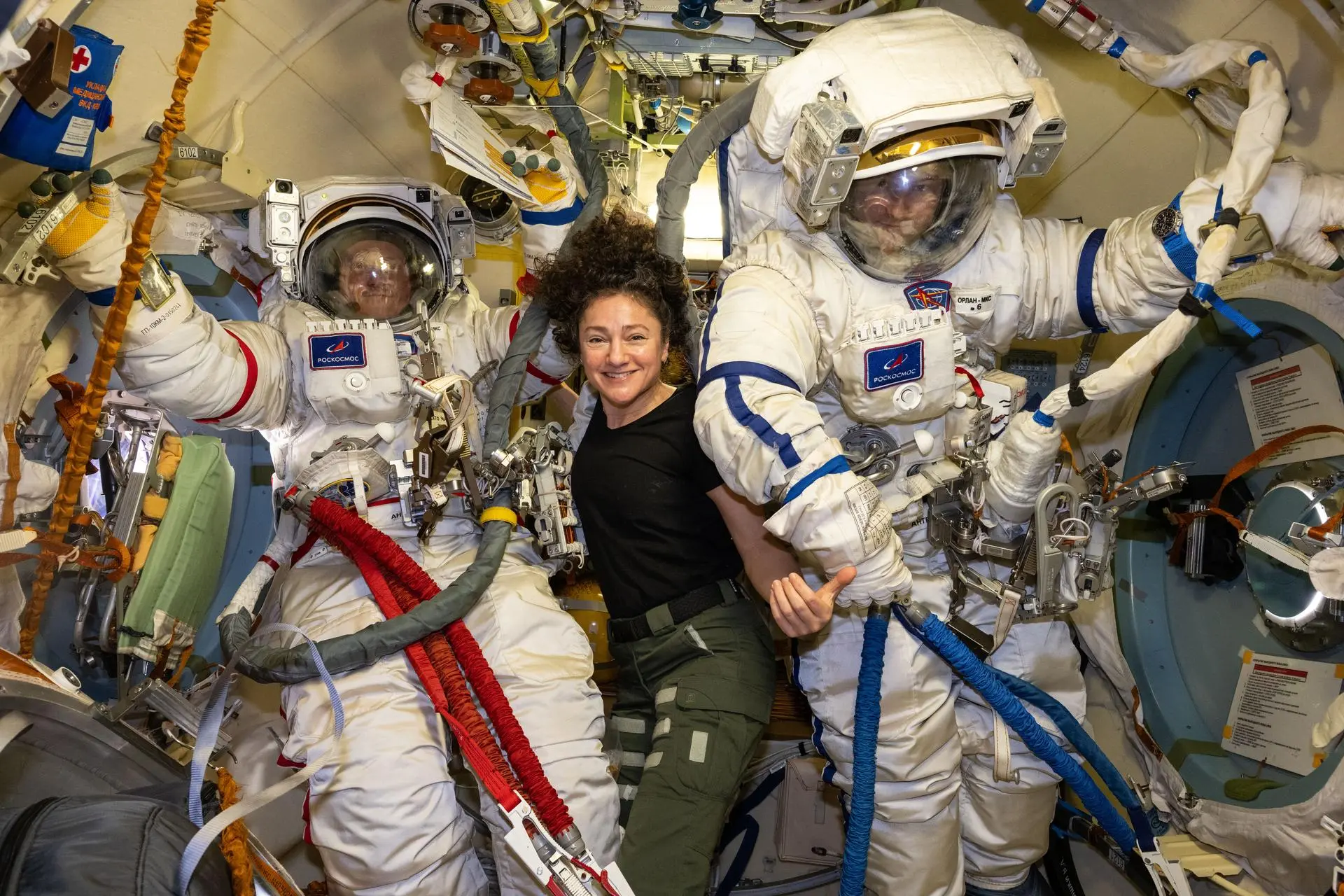 Roscosmos cosmonauts Sergey Kud-Sverchkov (left) and Sergei Mikaev (right), Expedition 74 commander and flight engineer respectively, are pictured inside the Poisk module's airlock trying on their Orlan spacesuits as NASA flight engineer Jessica Meir assists them. The duo was preparing for a spacewalk to install a solar radiation experiment and remove biological exposure hardware on the outside of the International Space Station.